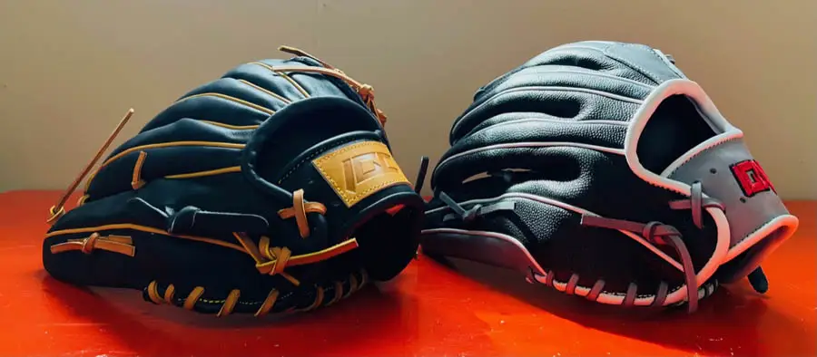 Two black baseball mitts on red table
